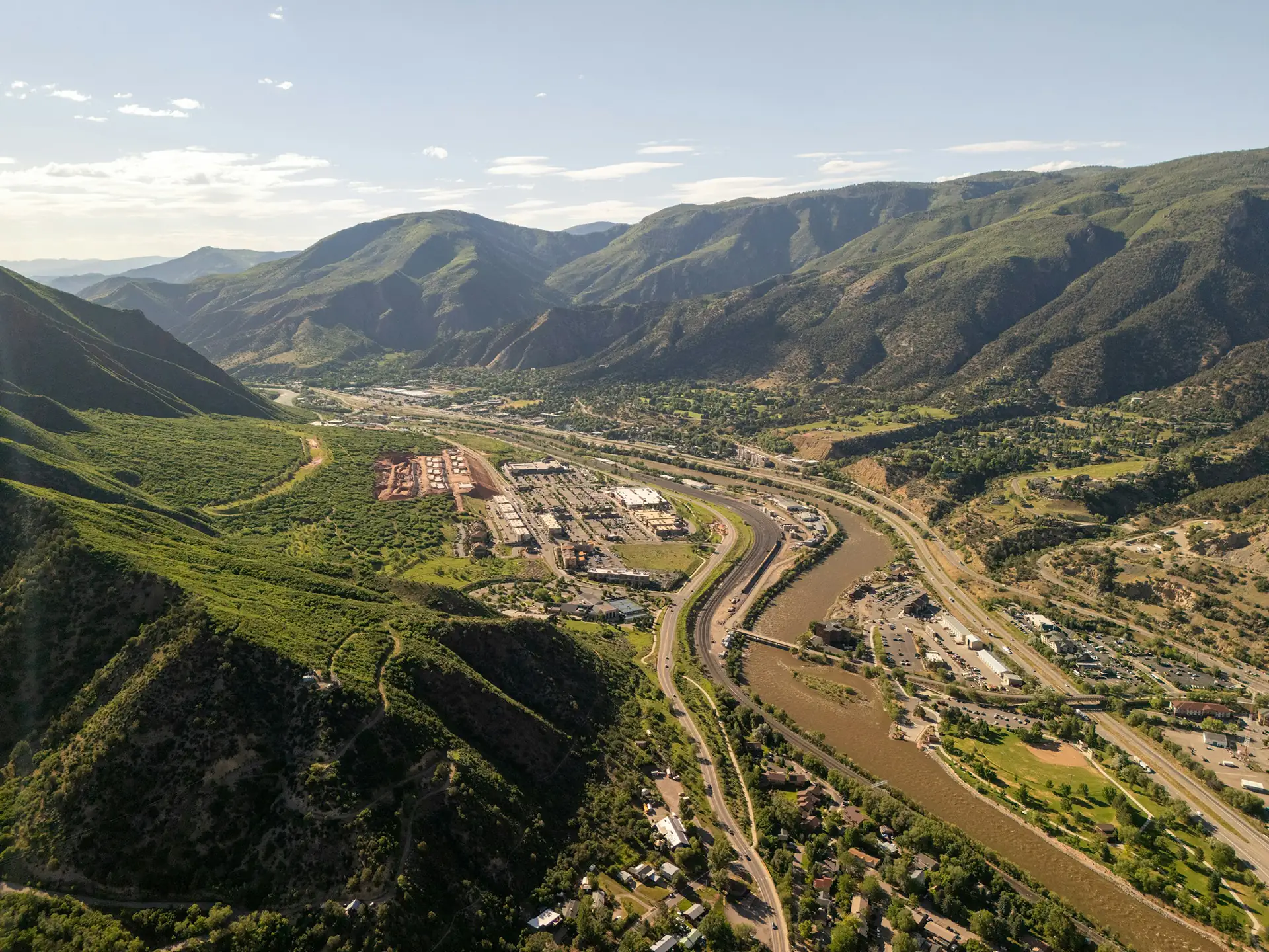 Aerial view of Glenwood Springs, Colorado, with the Colorado River and I-70 running through town between canyon walls