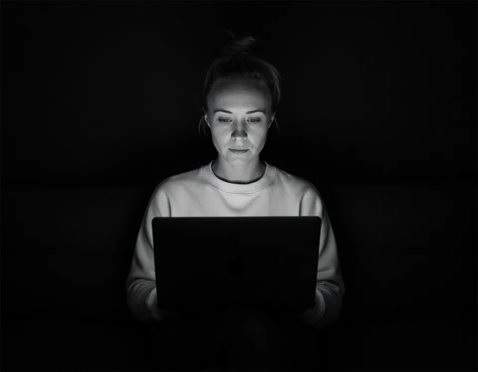 Katie Rutten of Bullfinch working on a laptop, in a black and white photo