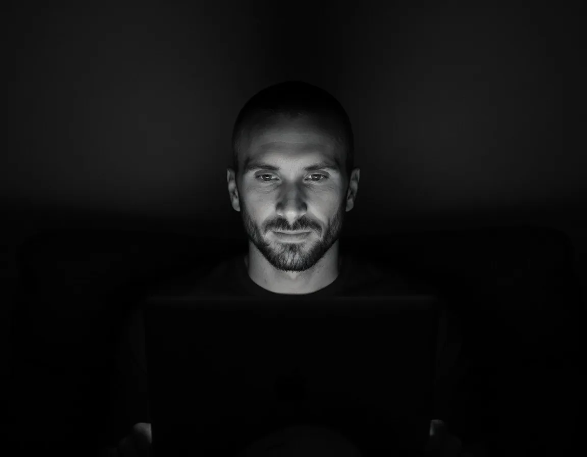 Kyle Rutten, Bullfinch's designer, lit by a laptop screen in a dark room