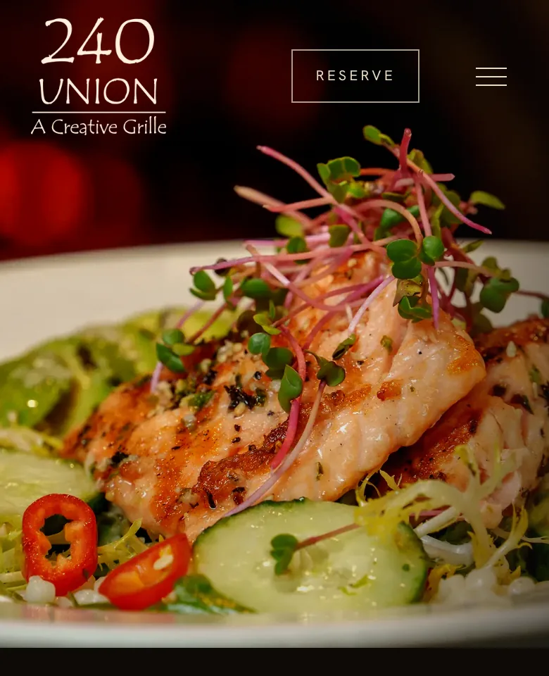 The top of 240 Union's homepage on a phone: the logo, a Reserve button and a plate of grilled salmon