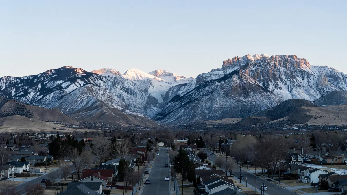 First light on Lone Peak and the mouth of Little Cottonwood Canyon above the quiet streets of Sandy, Utah